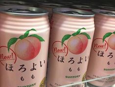 four cans of peach tea are on display in a store shelf with japanese writing and symbols