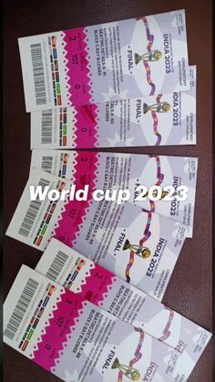 three tickets for the world cup 2013 are shown in pink and white paper with ribbons on them