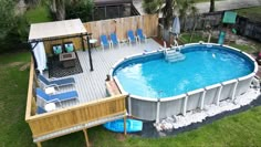 an above ground pool surrounded by lawn chairs