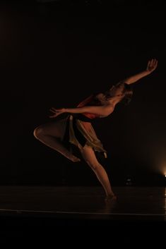 a woman standing on top of a wooden floor