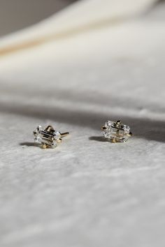 Celebrate the timeless beauty of our Emerald Cut Diamond Studs, known for their elegant rectangular shape and step-cut facets that create a mirror-like effect. These studs offer a sophisticated and refined look, perfect for those who appreciate understated elegance. Wear them with a classic black dress for an evening event or with a crisp white shirt for a polished day look. Their understated glamour makes them a versatile addition to any jewelry wardrobe. Available in 18K White, Yellow, or Rose Emerald Stud Earrings With Diamonds, Lab Grown Diamond Earrings, Emerald Cut Diamond Earrings, Emerald Cut Earrings, Diamond Studs Earrings, Emerald Studs, Beautiful Diamond Earrings, Luxury Jewelry Brands, Emerald Cut Diamond