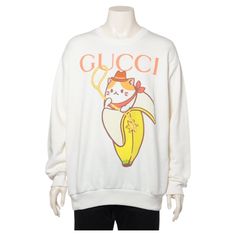 The Gucci x Bananya Cotton Pullover in white is a playful and stylish collaboration that blends high fashion with whimsical charm. Crafted from soft, high-quality cotton, the pullover features a unique design with Bananya, the beloved cat-banana character, playfully integrated into the Gucci aesthetic. The crisp white color enhances the vivid print, making it a standout piece for casual wear. With its comfortable fit and eye-catching graphics, the pullover embodies Gucci's signature blend of luxury and fun, adding a touch of personality to any wardrobe. CONDITION: 8/10. a few small marks Size: S Materials:Cotton Color:Ivory Shoulder width (cm): 54.5/21.45 inches Body width (cm):62/24.40 inches Length (cm): 75/29.52 inches Sleeve length (cm):64/25.19 inches Banana Character, Gucci Aesthetic, Gucci Brand, Mario Testino, Gucci Outfits, Knitted Hood, Cotton Long Sleeve Shirt, Cotton Pullover, Knit Sweatshirt