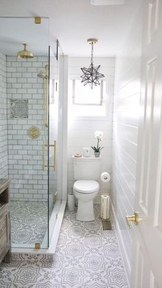 a white toilet sitting next to a walk in shower