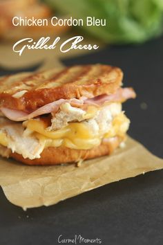 chicken cordon bleu grilled cheese sandwich on wax paper with lettuce in the background