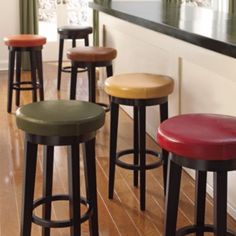 four stools are lined up in front of a bar with the words more colors on it