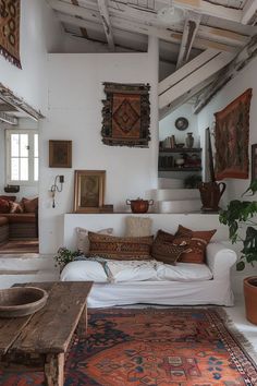 a living room filled with lots of furniture and rugs on top of a wooden table