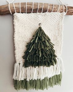 a green and white christmas tree hanging on a wall