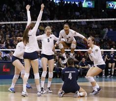 the volleyball team is celebrating their victory over the opponent in front of an enthusiastic crowd