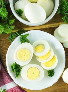 hard boiled eggs on a white plate with parsley