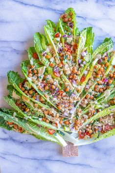 lettuce with chickpeas and garbanzo dressing on a marble surface