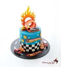 a birthday cake with cars and flames on top