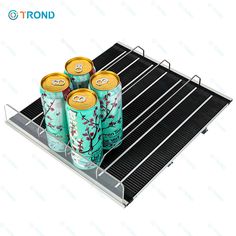 four cans of energy drink sitting on top of a cooling rack