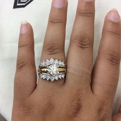 a woman's hand with two rings on it and a diamond in the middle