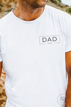 Complete with the ability to include the year of fatherhood, this dad shirt is the perfect gift for the dad in your life! See the sizing chart to ensure you choose your perfect fit. To ensure that your shirt always looks amazing, wash cold inside-out & refrain from ironing directly on the design. - Made with 100% cotton for year-round comfort that is sustainable and highly durable. - The classic fit of this shirt ensures a comfy, relaxed wear while the crew neckline adds that neat, timeless look that can blend into any occasion, casual or semi-formal. - The tear-away label means a scratch-free experience with no irritation or discomfort whatsoever. Note that no refunds or exchanges can be made since we custom create each shirt to your specifications & orders cannot be changed or canceled o Father's Day Family Shirt With Name Print, Family Matching Shirt With Name Print For Father's Day, Father’s Day Name Print Crew Neck Shirt, Customizable Crew Neck Shirt For Father's Day, Customizable Short Sleeve Shirt For Father's Day, Personalized White T-shirt For Father's Day, Father's Day Customizable Crew Neck Shirt, Father's Day Shirt With Name Print, Father's Day Customizable Short Sleeve Shirt