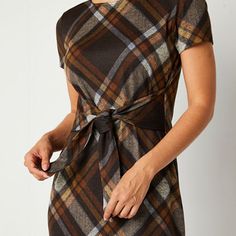 This R & K Originals women's plaid dress comes in earthy tones you'll love wearing with ankle boots and a blazer. Cut for a midi length from a soft stretch-knit, it has a round neck and a tie waist for definition. Neckline: Round NeckSleeve Length: Short SleeveSleeve Style: Fitted SleeveApparel Length: 43 InchesDress Length: Midi LengthFiber Content: 97% Polyester, 3% SpandexFabric Description: KnitCare: Machine Wash, Line DryCountry of Origin: Imported Black Dresses With Boots, Plaid Dress Outfit, Womens Plaid Dress, Carol Tuttle, Large Dresses, Flare Dresses, Medium Dresses, Small Dresses, Window Home Decor