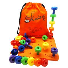 an orange bag filled with lots of colorful plastic beads next to a set of wooden pegs