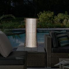 an outdoor living area with furniture and lighting