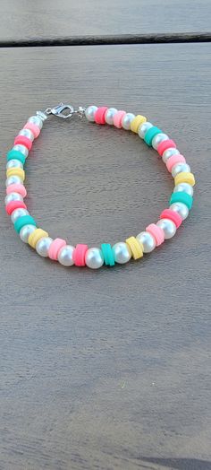 Add some accessories to your outfit with this pearl and clay bead pastel bracelet! This bracelet is perfect for a summer day and throughout the year! All bracelets are made with lobster clasps. All bracelets come with a care card. Usually ships between 1-3 business days. All bracelets are 7 inches long. Please contact me with any questions or concerns! Bracelet Ideas Summer Clay Beads, Bracelet Making Ideas Clay Beads, Cute Clay Bead Bracelet Ideas For Summer, Hieshi Clay Bracelets, Cute Bracelet Ideas For Summer, Pastel Clay Bead Bracelet, Clay Bead Bracelet Ideas With Pearls, Braclets Ideas Beads Easy, Clay Bead Bracelet Ideas Summer Preppy