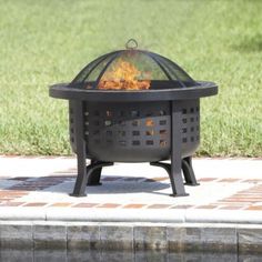 a fire pit sitting on top of a brick patio