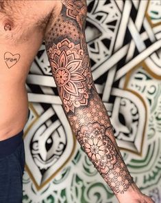 a man's arm with tattoos on it