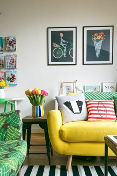 a living room filled with furniture and pictures on the wall