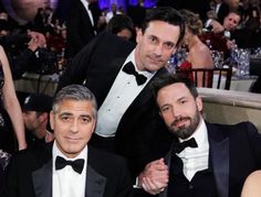 three men in tuxedos are posing for a photo at an oscars event