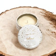 a candle sitting on top of a wooden slice