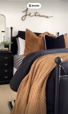 a bed room with a neatly made bed and pillows