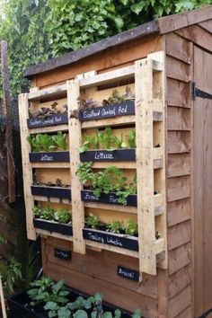 a garden shed with plants growing on the side and words written on it that read,