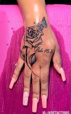 a woman's hand with a rose tattoo on it