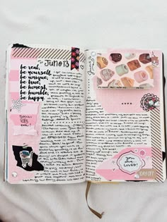 an open journal with pink and black designs on the pages is laying on a bed