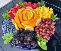 a blue plate topped with fruits and vegetables