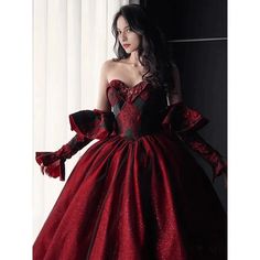 This Gothic Black And Red Wedding Dress With Gloves is sure to make a statement on your special day. Featuring a classic Burgundy Ball Gown silhouette, this dress is crafted from fine, luxurious fabrics and adorned with intricate embroidery. The sweeping skirt is adorned with delicate lace embroidery, while the bodice is tailored with a corset-style top and adjustable ribbon straps. The long, elegant gloves of this dress add a touch of sophistication, while the deep red and black colors lend a Elegant Red Evening Dress For Winter, Red Ball Gown For Banquet, Fitted Evening Dress For Winter Wedding, Red Elegant Ball Gown For Banquet, Red Ball Gown Wedding Dress For Banquet, Red Fitted Ball Gown Evening Dress, Red Fitted Ball Gown, Fitted Red Ball Gown For Prom, Red Corset Dress For Gala During Prom Season