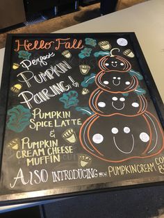 a chalkboard sign with an image of a pumpkin sitting on it's side