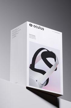 the box is open to reveal an image of a pair of headphones on display