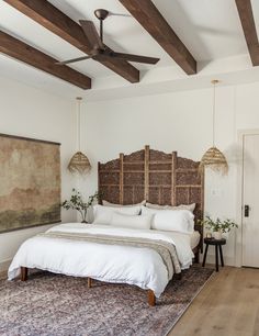 a bedroom with a bed, rug and ceiling fan