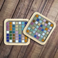 two coasters made out of wood with colorful glass tiles on the top and bottom