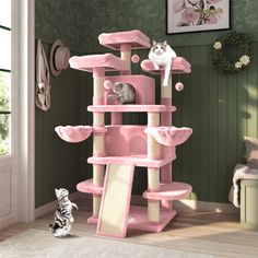 a cat tree with two cats in it and one on the ground looking at another cat