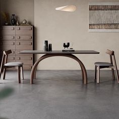 a dining table with two chairs next to it