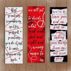 three bookmarks with handwritten words on them in red, white and black colors