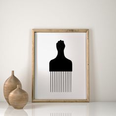 a black and white photo of a woman's head with hair combs on it next to a vase