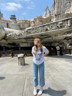 a woman standing in front of a star wars land