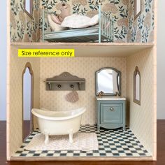 the dollhouse is made to look like it has a bathtub and sink in it