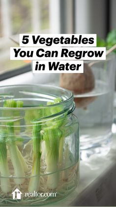 some vegetables are in small glass containers on a window sill