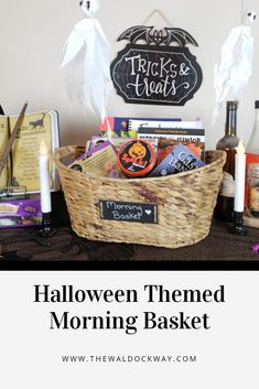 halloween themed morning basket with candles, candy and other items in it on a table