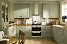 an image of a kitchen setting with green cabinets