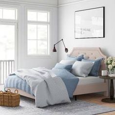 a bed with blue and white sheets in a bedroom