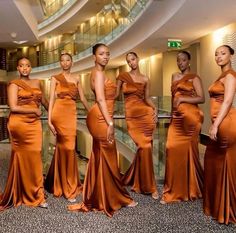 the beautiful women in orange dresses are posing together