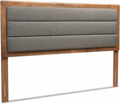 the headboard is made out of wood and has grey upholstered fabric on it