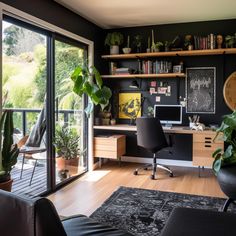 an office with black walls and lots of plants on the desk, along with a large sliding glass door that leads to a balcony